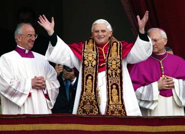 Pope Benedict XVI waves from a balcony of St. Peter's Basilica